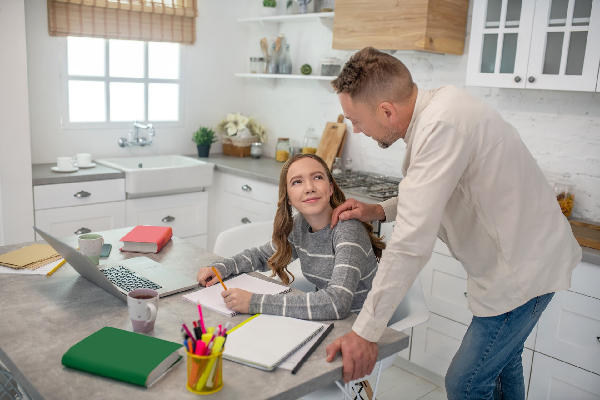 Father teaching financial literacy to teen